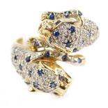 A 9ct gold sapphire and diamond double panther ring, Panthere de Cartier style, size N, 6.4g.