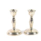 A pair of loaded silver candlesticks, of hour glass form, Birmingham 1959, 10cm H, 7.86oz all in.