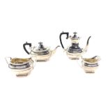 A George V silver four piece tea and coffee set, of fluted baluster form, comprising tea pot, coffee