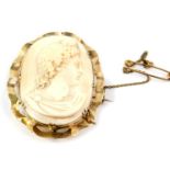 An oval cameo brooch, bust portrait of a Roman Emperor, in a yellow metal frame with safety chain.