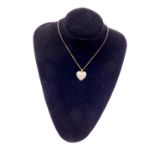A 9ct gold and diamond cluster set heart shaped pendant, on an oval link neck chain, unmarked, and a