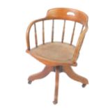 A Victorian oak captain's swivel armchair, with a bentwood seat, raised on a cast iron mechanism and