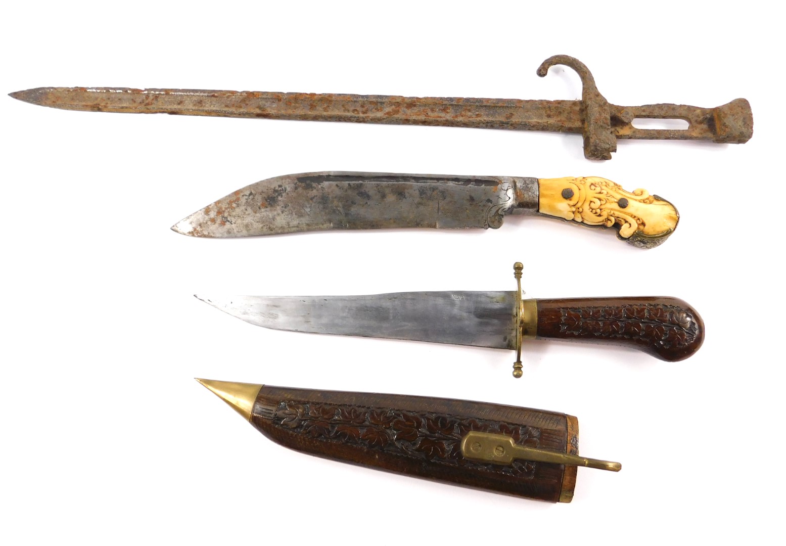 A 19thC hunting knife, possibly Indonesian with an engraved steel blade, and carved ivory and