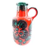 A Scheurich 1970's pottery fat lava vase, decorated in green with stylized flowers against a red