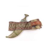 A Yemeni Jambiya, the horn hilt with metal embellishments, double edged steel blade and Asib cloth