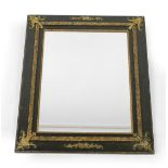 A Victorian green stained and parcel gilt rectangular wall mirror, inset bevelled glass with brass