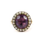 A 19thC amethyst and seed pearl ring, set in closed back yellow metal, size S, 7.8g.