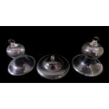 A pair of Victorian glass cloches, or smoke domes of bell form, with an everted rim, 29cm H, 26cm