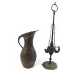 A 19thC brass oil lamp, of Roman oil lamp form, with long carrying handle, the body with three