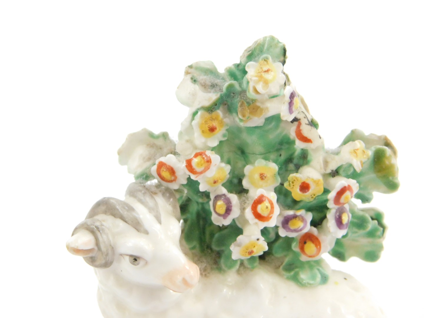 A late 18thC Derby porcelain figure of a Putto, modelled standing holding a basket of flowers, - Image 2 of 4