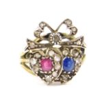 A 9ct gold diamond sapphire and ruby 'Love' ring, formed as a pair of conjoined hearts, surmounted