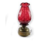 An early 20thC French Veritas Lampe brass room heater, with chimney, and ruby glass shade, 53cm H.