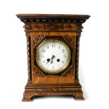 A Maple & Co late 19thC oak cased mantel clock, circular dial bearing Arabic numerals, French