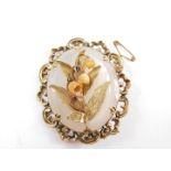 A Victorian Lily of the Valley brooch, with ivory Trembluse flowers and yellow metal leaves, on a