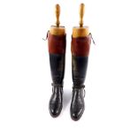 An early 20thC pair of black and tan leather riding boots, by Bartley & Sons, Oxford St, West