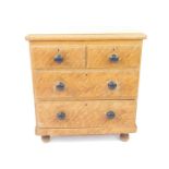 A Victorian scumbled pine chest of drawers, with two short over two long drawers, raised on turned