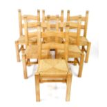 A set of six light beech ladder back single dining chairs with rush seats, raised on square legs,