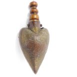 A 19thC Ottoman wooden and horn powder flask, with carved decoration and brass overlay, iron ring