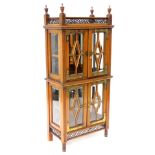 An unusual late 19th/early 20thC aesthetic style side cabinet, the fretwork galleried top, with