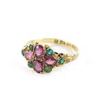 A Victorian cluster ring, set with four pale pink garnets, flanked by six emeralds, in yellow