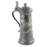 A 17thC pewter plain sided flagon, with a shaped thumb piece, (AF), 29cm H.