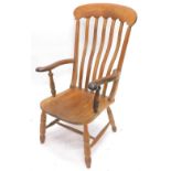 A 19thC lath back Windsor armchair, with shaped supports, solid seat and turned legs with H