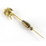 A cherub stickpin, with single cherub type figure, praying, in Bournemouth Goldsmiths box,