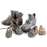 Various pairs of leather child's shoes or boots.