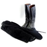 A pair of black leather size 9 riding boots, an ebonised walking cane and a black Saddle Master