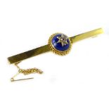 A 15ct gold bar brooch, with central cabochon cut stone, with star design centre, set with tiny