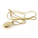 A gold locket pendant and chain, the locket set with hatch design tiny diamonds, stamped to rear