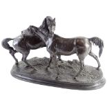 After Mene. A bronzed spelter figure of two horses, accolade number 2, on oval moulded base, 52cm