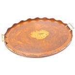 A burr walnut oval galleried tray, inlaid centrally with a shell with brass handles, 60cm W.