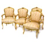 A set of four French gilt gesso fauteil or open armchairs, each with a moulded frame embellished