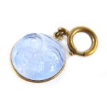 A moon face key ring charm, with two sided moon face, in pale blue paste stone, in a gilt metal