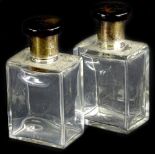 A pair of George V glass scent bottles, each with a simulated tortoiseshell and silver lid and an