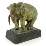 An early 20thC cold painted spelter figure of an elephant, in the manner of Bergman, on an iron