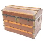 An early 20thC canvas and wooden dome top trunk, with side carrying handles, 77cm W.