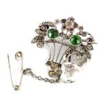 A silver basket brooch, set with various multi coloured paste stones, including green, pink,