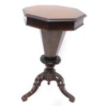 A Victorian figured walnut trumped shaped work table, the octagonal hinged top enclosing a fitted