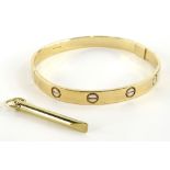 A 9ct gold bangle, with etched design, makers stamp BD, Sheffield assay, with winder, 6.5cm dia,