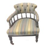 An Edwardian button back armchair, upholstered in striped fabric on square tapering legs with
