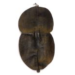 An African Tanzanian Sukuma hide tribal shield, of hour glass shape with ebonised handle, 72cm H,