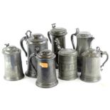 A collection of seven 19thC and later lidded pewter tankards, each with a shaped thumb piece, to