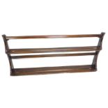 An Ercol elm plate rack, with shaped end supports, 96cm W.