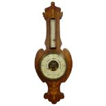 An Edwardian mahogany and marquetry wheel barometer by Dolland of London, the shaped case