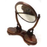 A Victorian mahogany swing frame dressing table mirror, with oval plate on shaped supports, the base
