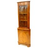 A yew veneered bow fronted corner cabinet, the top with with a single glazed door above a plain door