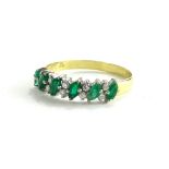 An 18ct emerald and diamond half hoop eternity ring, set with marquise cut emeralds, broken by two