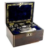 A Victorian rosewood and pewter strung dressing case, the hinged lid inset with a mother of pearl